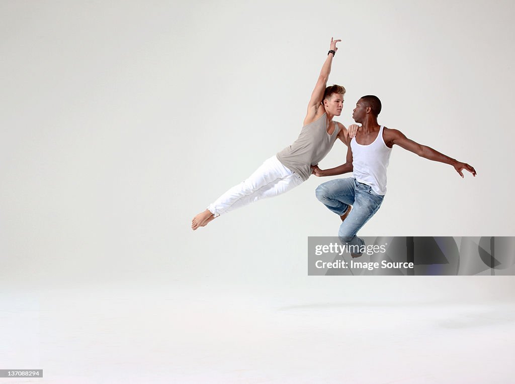 Two young men in mid air