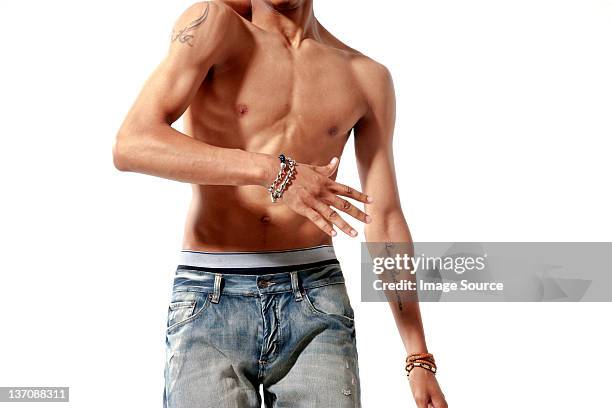 mid section of bare chested young adult man - slim man stock pictures, royalty-free photos & images