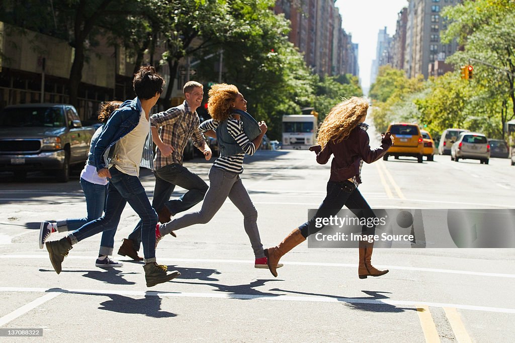 Five friends running through city street