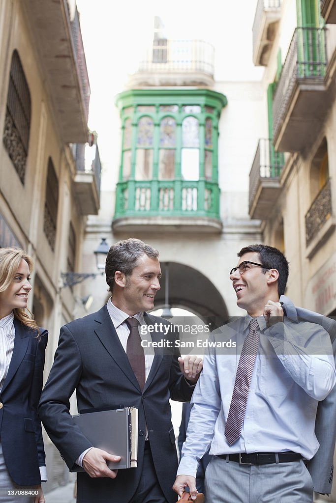 Business people walking together on city street