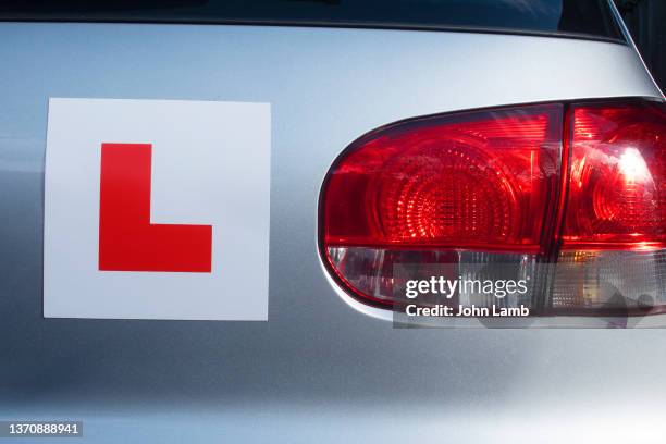 l-plate on the rear of silver car. - learning to drive stock pictures, royalty-free photos & images