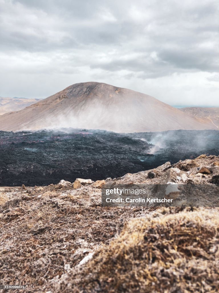 Glowing lava flow in a barren landscape | Iceland