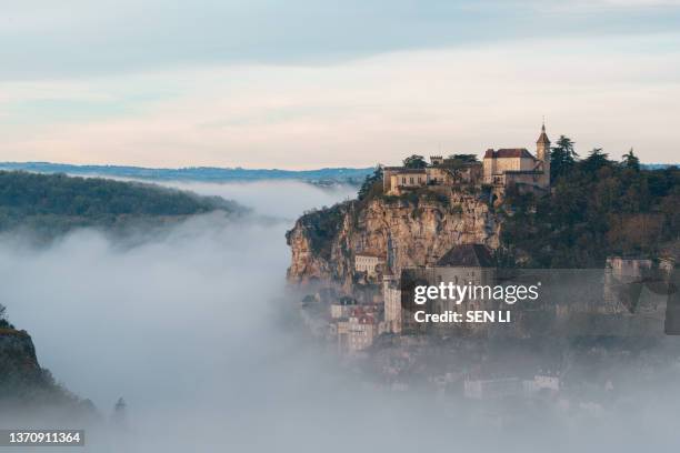 rocamadour sunrise, aerial view of the french village and castle on cliff in early morning with fogs in the canyon of the alzou - midirock stock pictures, royalty-free photos & images