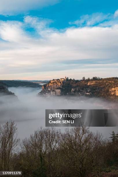 rocamadour sunrise, aerial view of the french village and castle on cliff in early morning with fogs in the canyon of the alzou - rocamadour ストックフォトと画像