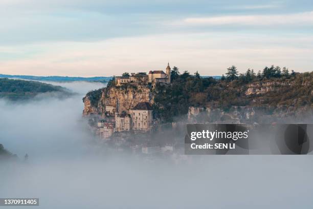 rocamadour sunrise, aerial view of the french village and castle on cliff in early morning with fogs in the canyon of the alzou - ドルドーニュ ストックフォトと画像