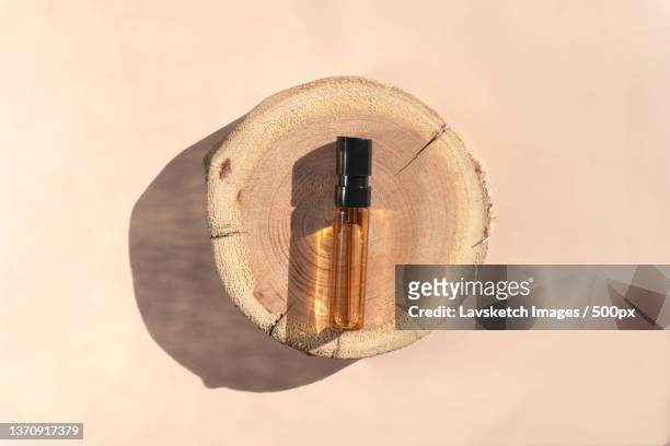 perfume tester with brown liquid on a wooden tray top view - fleur macro stock pictures, royalty-free photos & images