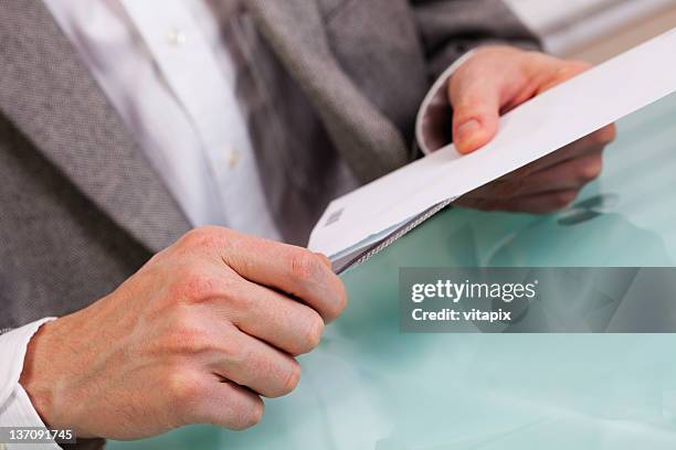 business person opening an envelope - utility knife stockfoto's en -beelden