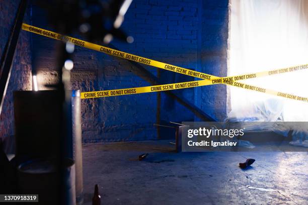 crossed police lines at the crime scene - murder victim stock pictures, royalty-free photos & images