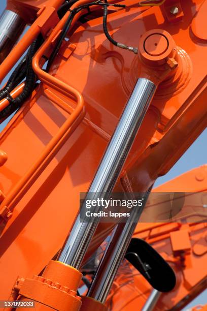 closeup view of an orange hydraulic system - piston stock pictures, royalty-free photos & images