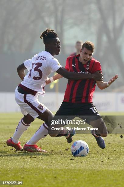 Ange Caumenan N'Guessan of of Torino FC competes for the ball with Youns El Hilali of AC Milan U19 during the match beetwen AC Milan U19 and Torino...