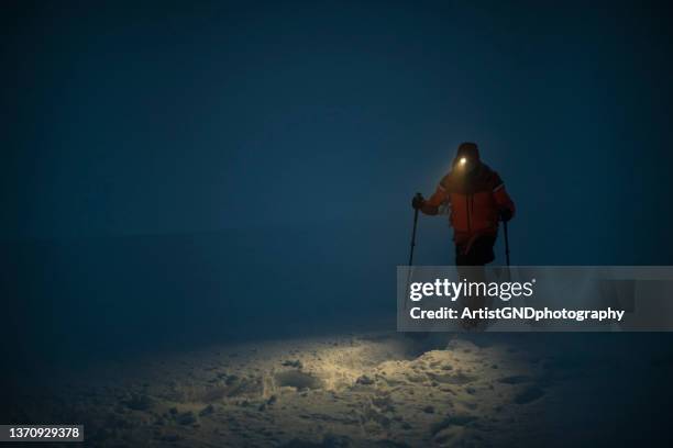 mountaineering at night time. - winter_storm stock pictures, royalty-free photos & images