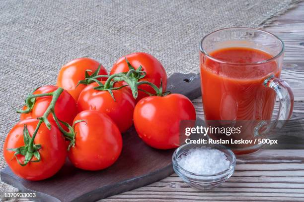 high angle view of tomatoes with juice on table,russia - vegetable juice stock pictures, royalty-free photos & images