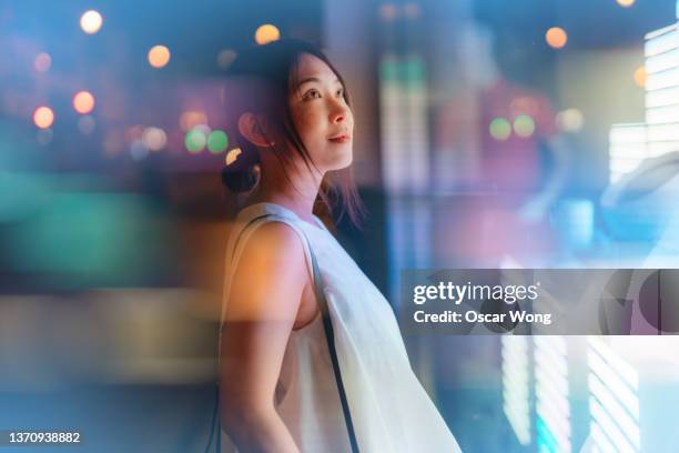 young woman looking at futuristic digital display. - sci fi stockfoto's en -beelden