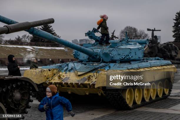 Children play on tanks displayed at the Motherland Monument on the newly created "Unity Day" on February 16 in Kyiv, Ukraine. "Unity Day" was created...