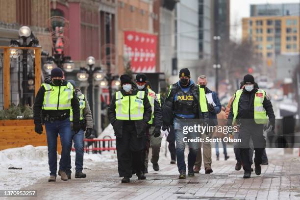 Police patrol near the parliament building as a demonstration led by truck drivers protesting vaccine mandates continues on February 16, 2022 in...