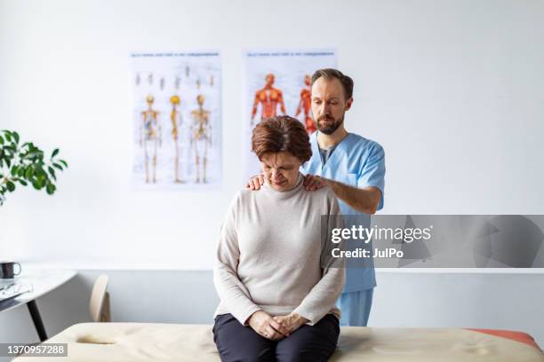 physical therapist helping senior woman with her neck - human head stock pictures, royalty-free photos & images