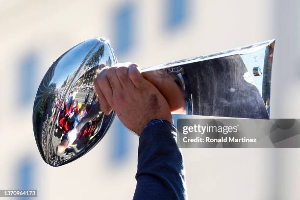 Andrew Whitworth of the Los Angeles Rams raises the Vince Lombardi trophy during the Los Angeles Rams Super Bowl LVI victory parade on February 16,...
