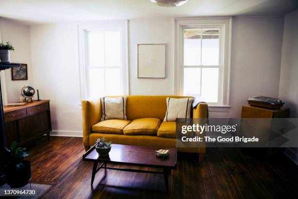 wide shot of living room with sofa and desk - antique sofa styles foto e immagini stock