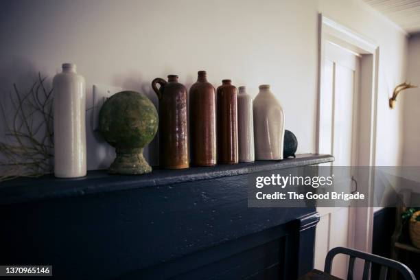 ceramic jugs on fireplace mantle in dining room - mantelpiece stock pictures, royalty-free photos & images