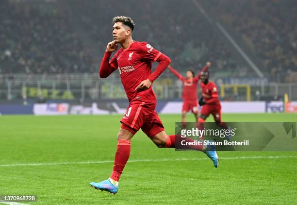Roberto Firmino of Liverpool celebrates after scoring their side's first goal during the UEFA Champions League Round Of Sixteen Leg One match between...