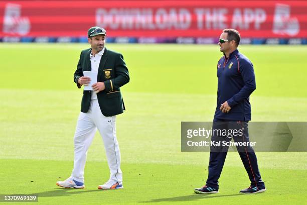 Captain Dean Elgar and Head Coach Mark Boucher of South Africa look on prior to day one of the First Test Match in the series between New Zealand and...