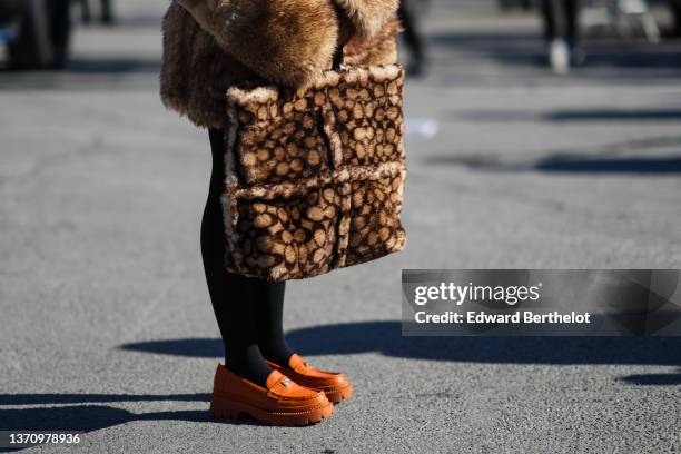 Guest wears a brown and beige tie and dye oversized fur / fluffy coat, a matching brown and beige tie and dye oversized fur / fluffy handbag, black...