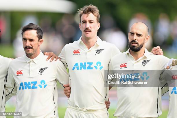 Hamish Rutherford, Blair Tickner and Daryl Mitchell of New Zealand line up for their national anthem prior to day one of the First Test Match in the...