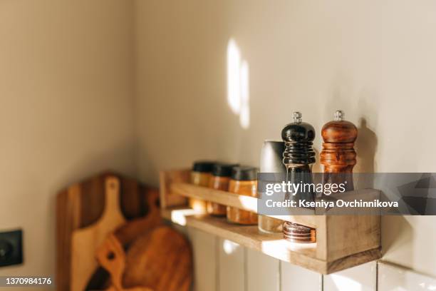 modern kitchen shelves with various food ingredients on white background - origano foto e immagini stock