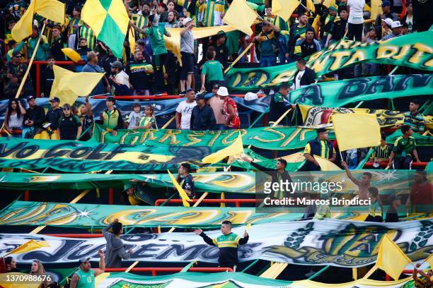 Fans of Aldosivi cheer their team with flags during a match between Aldosivi and Boca Juniors as part of Copa de la Liga 2022 at Estadio Jose Maria...