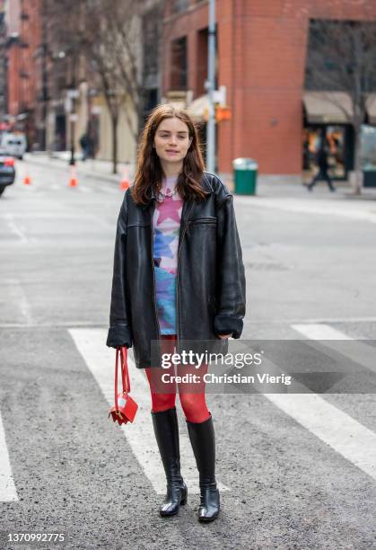 Reese Blutstein & Molly Blutstein wearing red tights, dress with print, black leather jacket, knee hight boots, necklec seen outside Collina Strada...