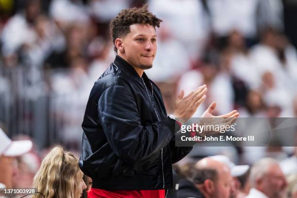 Quarterback Patrick Mahomes of the Kansas City Chiefs claps during the first half of the college basketball game between the Texas Tech Red Raiders...