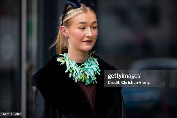 Guest is seen wearing sheer tights with dots print, black leather coat with shearling collar, necklace outside Prabal Gurung during New York Fashion...