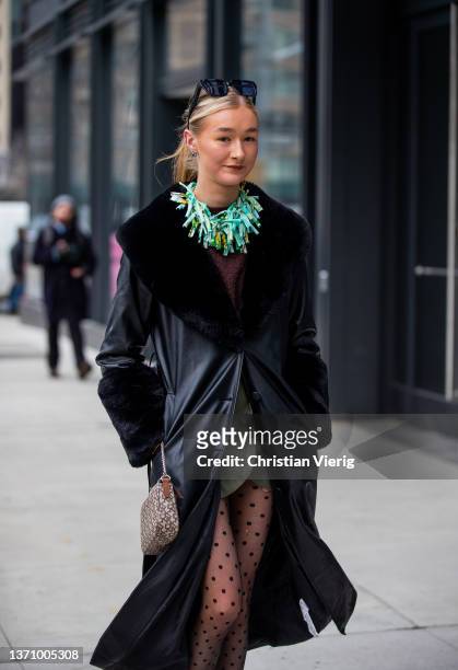 Guest is seen wearing sheer tights with dots print, black leather coat with shearling collar, necklace outside Prabal Gurung during New York Fashion...