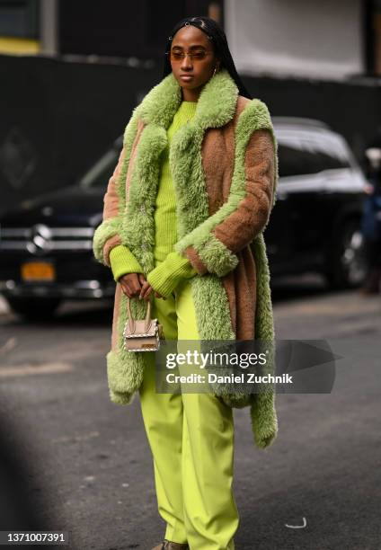 Candace Marie is seen wearing a lime green faux fur coat, lime green sweater and pants with a Jacquemus mini bag outside the Collina Strada show...