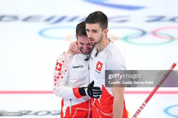 Peter De Cruz of Team Switzerland reacts with teammate Valentin Tanner after defeating Team Sweden during the Men’s Curling Round Robin Session on...