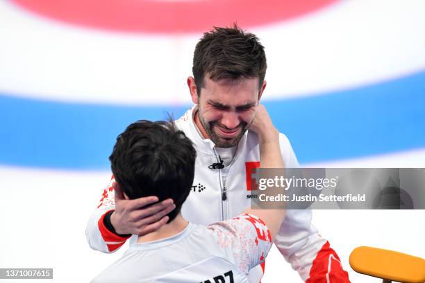 Peter De Cruz of Team Switzerland reacts with teammate Valentin Tanner after defeating Team Sweden during the Men’s Curling Round Robin Session on...