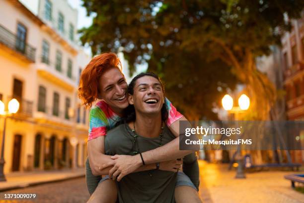 carry a person on your shoulders - piggyback stock pictures, royalty-free photos & images