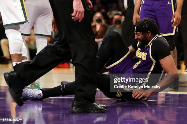 Anthony Davis of the Los Angeles Lakers holds his ankle after an injury during the second quarter against the Utah Jazz at Crypto.com Arena on...
