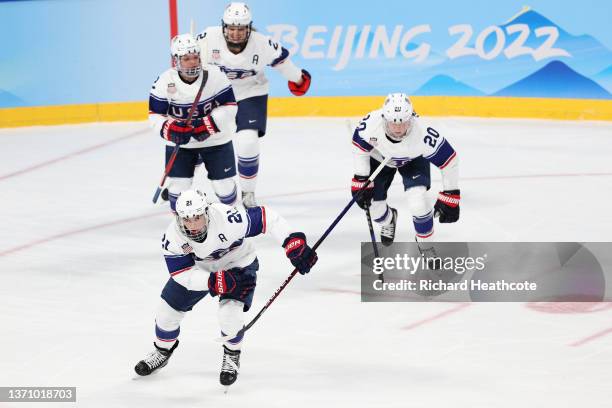 Hilary Knight of Team United States skates to the team bench after celebrating scoring a goal in the second period with Cayla Barnes, Lee Stecklein...