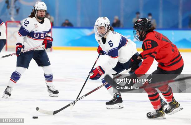 Megan Keller of Team United States and Melodie Daoust of Team Canada vie for the puck in the third period during the Women's Ice Hockey Gold Medal...