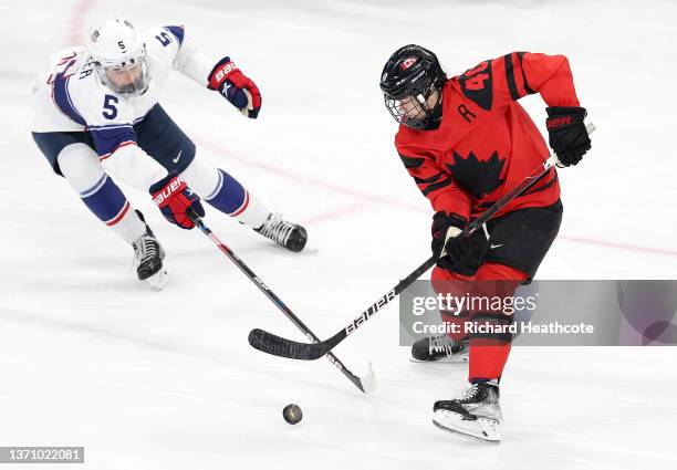 Blayre Turnbull of Team Canada and Megan Keller of Team United States vie for the puck in the third period during the Women's Ice Hockey Gold Medal...