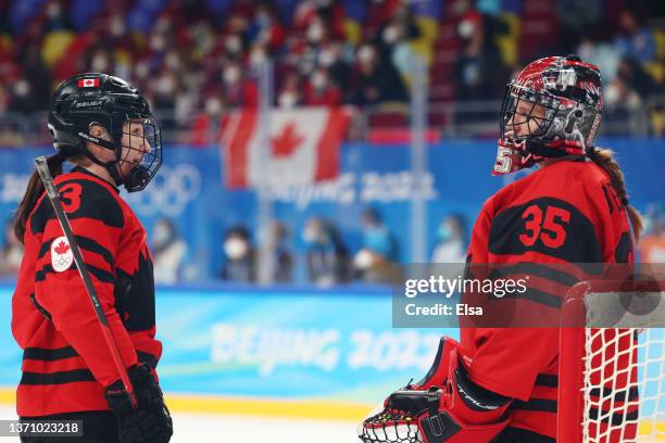 Goaltender Ann-Renee Desbiens of Team Canada talks with Jocelyne Larocque in the third period during the Women's Ice Hockey Gold Medal match between...