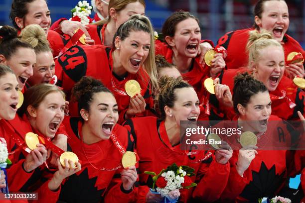 Team Canada poses for photos with their gold medals during the medal ceremony after the Women's Ice Hockey Gold Medal match between Team Canada and...