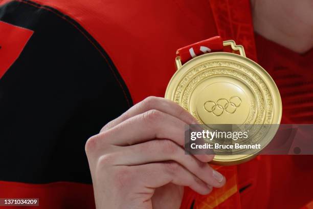 General view of a Team Canada player holding up their gold medal as they celebrate during the medal ceremony after the Women's Ice Hockey Gold Medal...