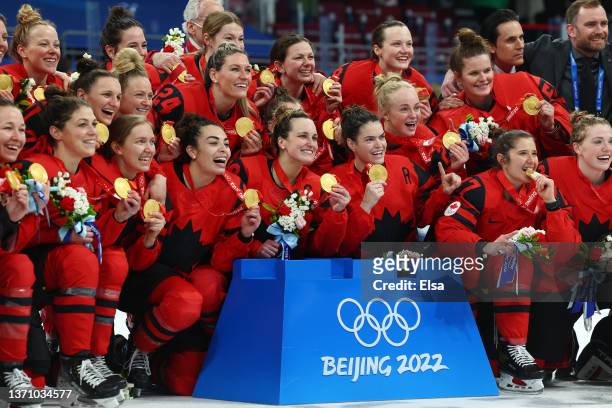 Team Canada poses for photos with their gold medals after the Women's Ice Hockey Gold Medal match between Team Canada and Team United States on Day...