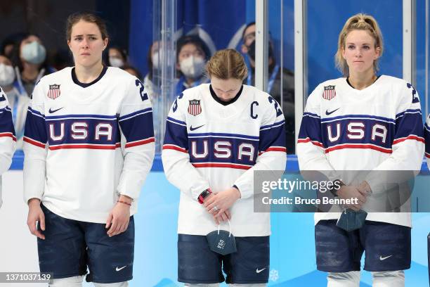 Alex Carpenter, Kendall Coyne Schofield, and Amanda Kessel of Team United States line up for their silver medals after the Women's Ice Hockey Gold...