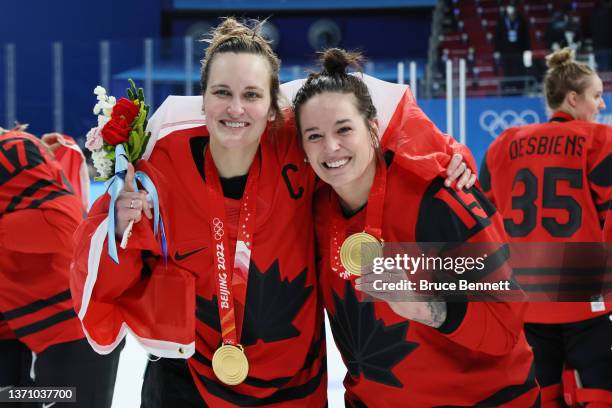 Gold medal winners Marie-Philip Poulin and Melodie Daoust of Team Canada celebrate during the medal ceremony after the Women's Ice Hockey Gold Medal...