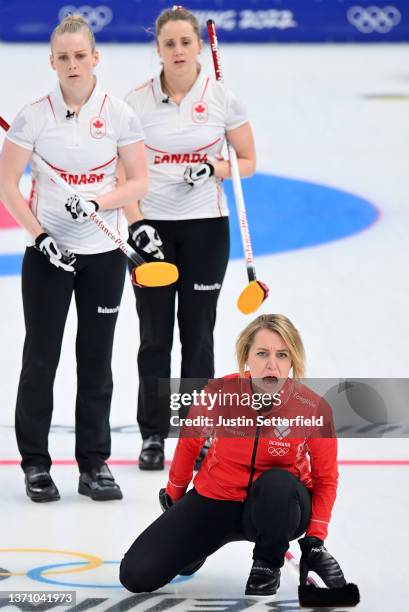 Madeleine Dupont of Team Denmark reacts as Jocelyn Peterman and Dawn McEwen of Team Canada look on during the Women’s Curling Round Robin Session on...