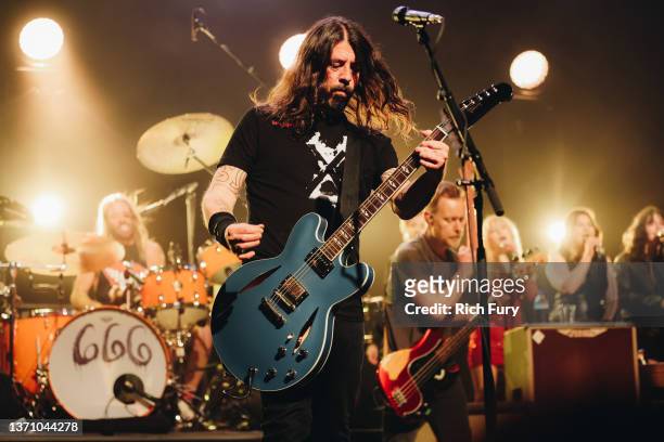 Taylor Hawkins, Dave Grohl and Nate Mendel of Foo Fighters performs onstage at the after party for the Los Angeles premiere of "Studio 666" at the...