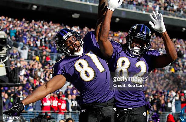 Anquan Boldin of the Baltimore Ravens celebrates scoring a touchdown with teammate Torrey Smith against the Houston Texans during the first quarter...